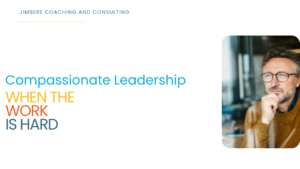 A professional man reflecting and looking outside the window. Article title and invitation to read Compassionate Leadership When the Work Is Hard.